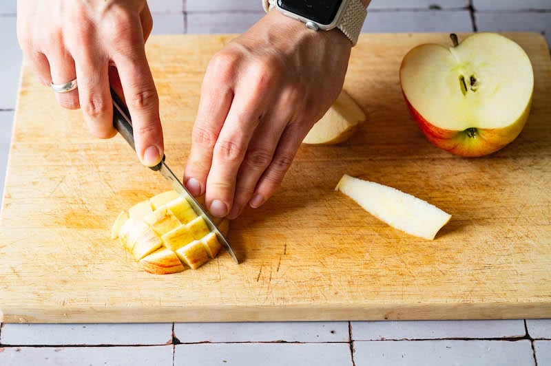 Apple being cut into small pieces.