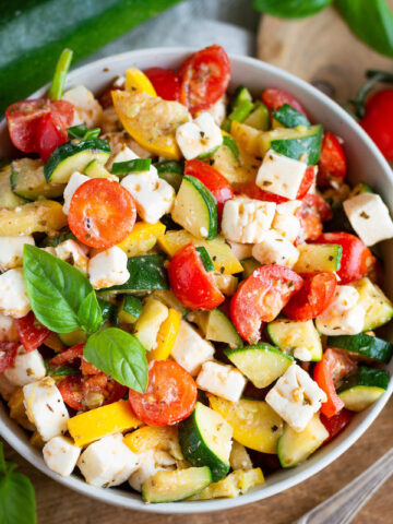 Roasted zucchini salad with yellow squash, tomatoes and feta cheese.